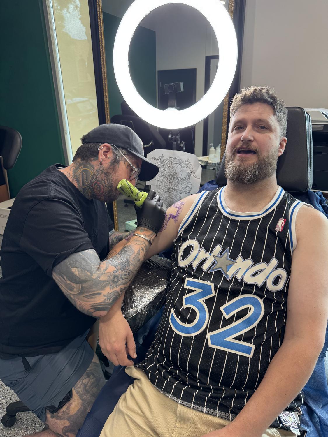 An artist and client mid-session at Mother Goose Tattoo